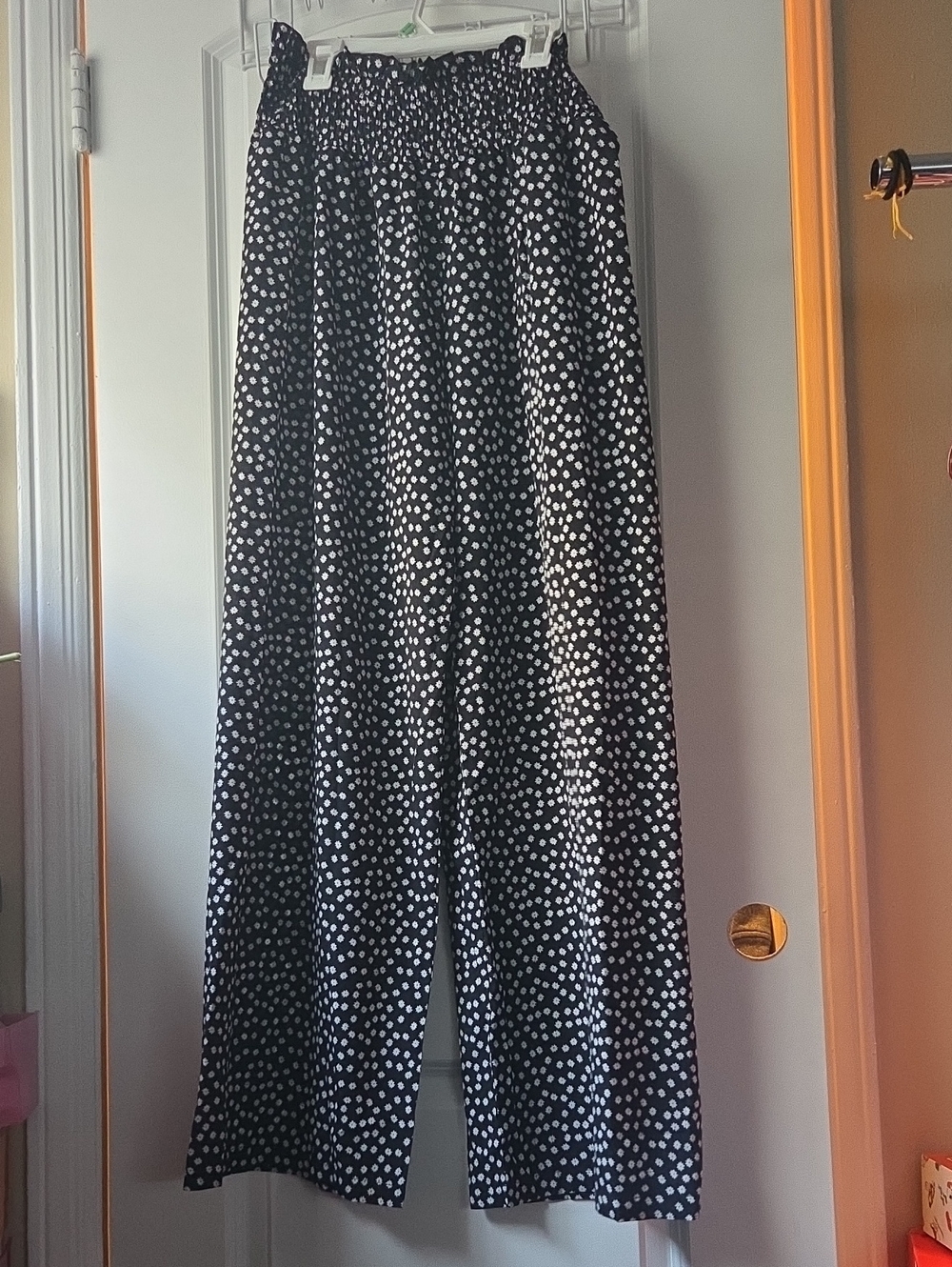Black Flared Leg Pants With White Daisy Like Pattern